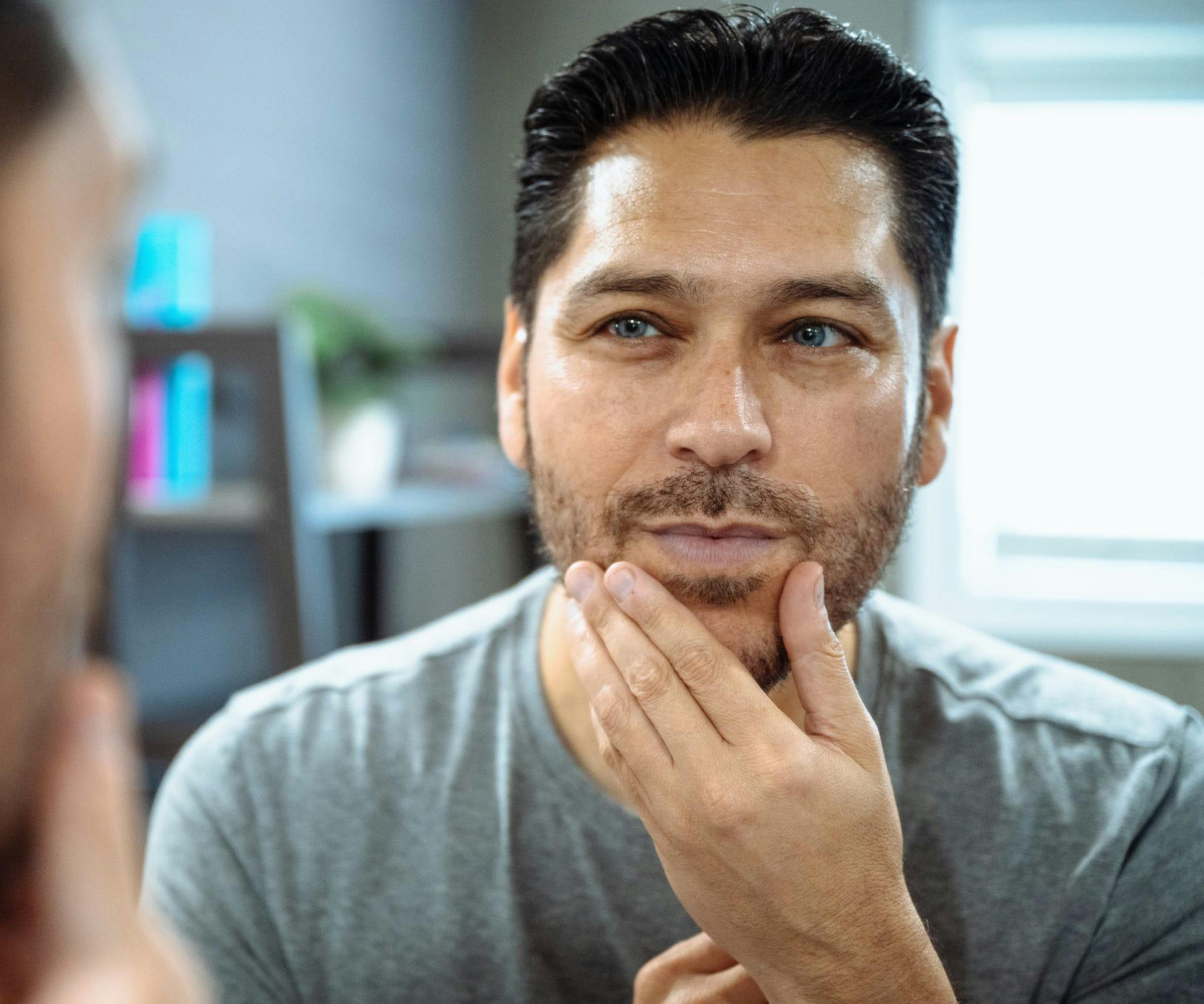 man touching his beard