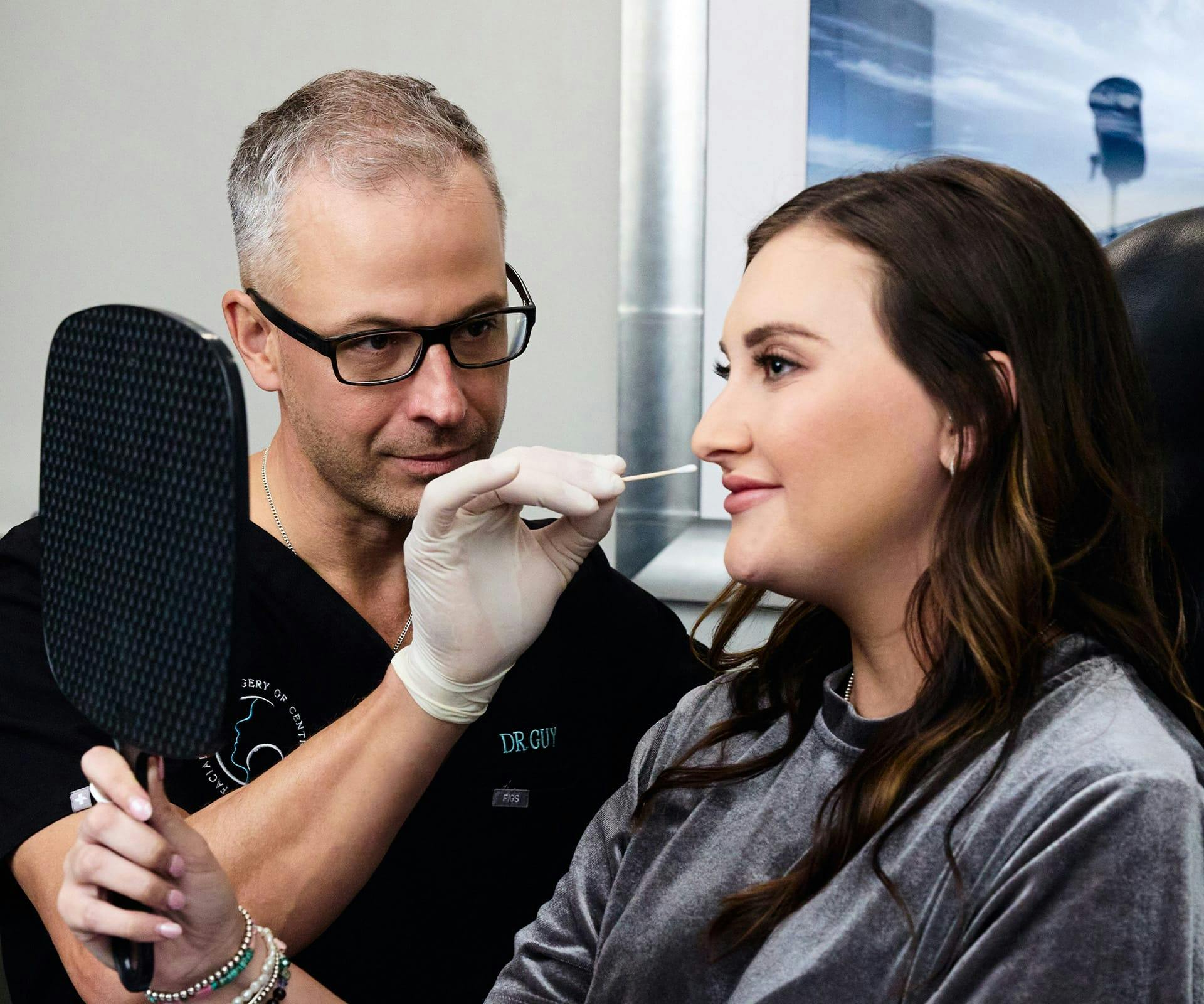 Dr. Guy looking at patient's face